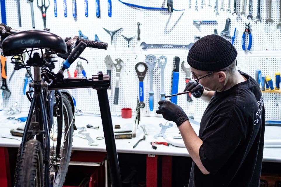 a man working on a bike in a garage